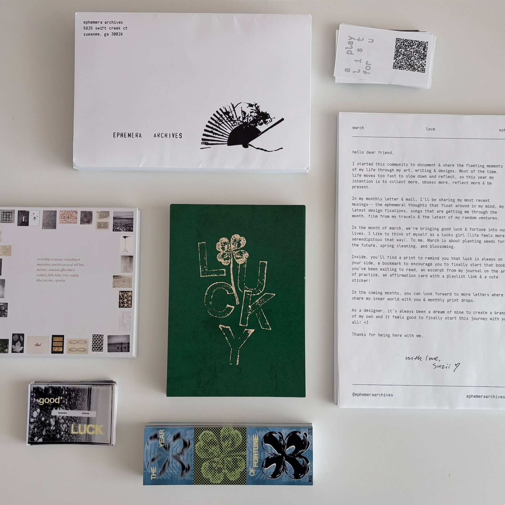 Collection of stationery items including envelopes, cards, and a letter on a white surface.